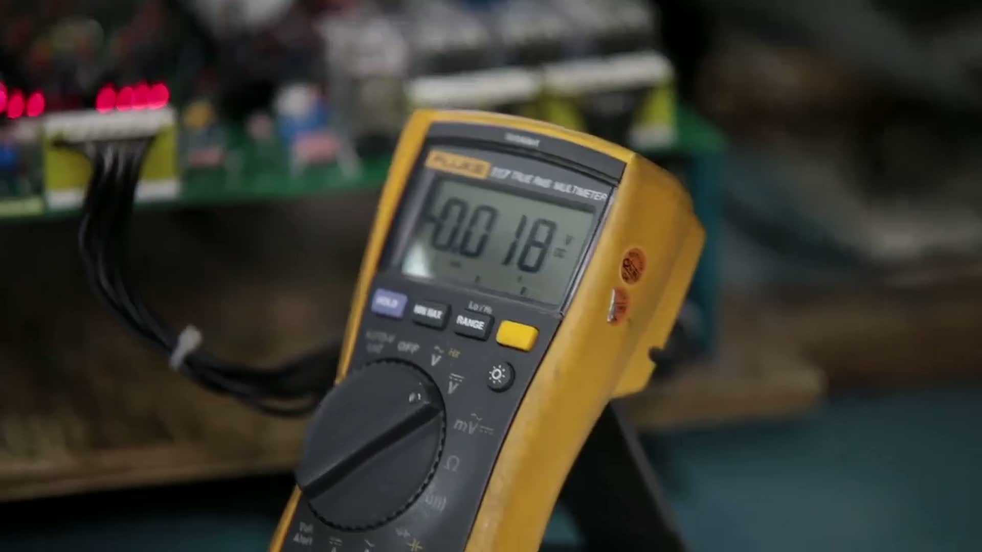 Multimeter measuring a board on VRI's repair bench