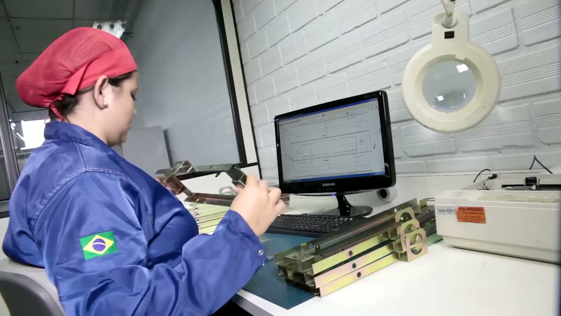 VRI operator at a prototyping bench with a lit magnifier